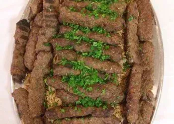 A plate of food with meat and rice on a table.
