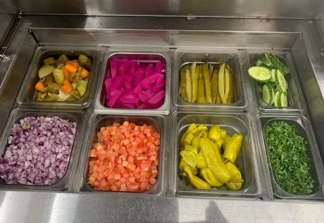 There are many different types of vegetables in the trays.