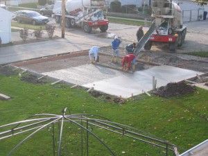Pouring of concrete foundation for new garage. Concrete is 4″ thick.