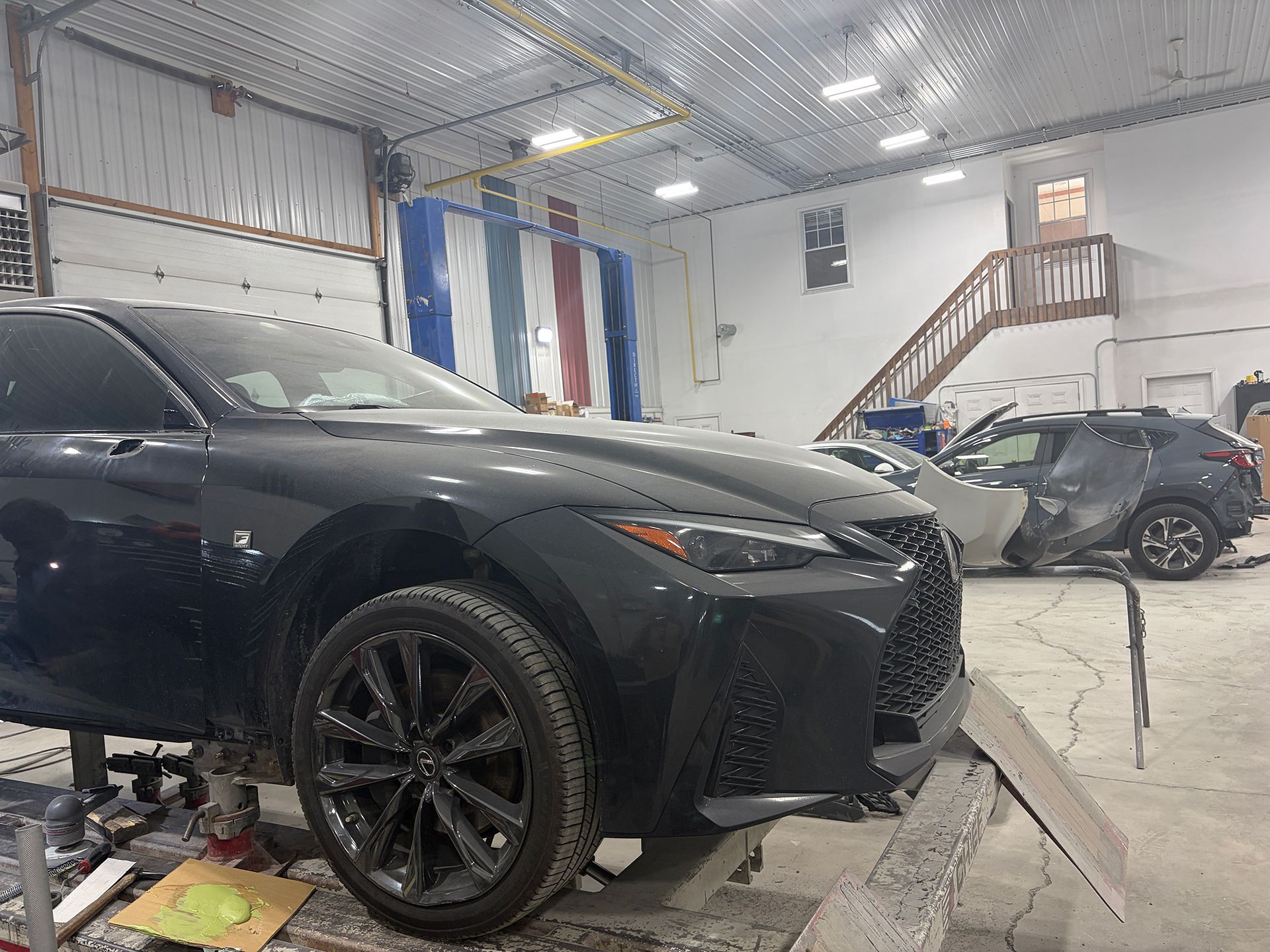 Black damaged car in an auto shop