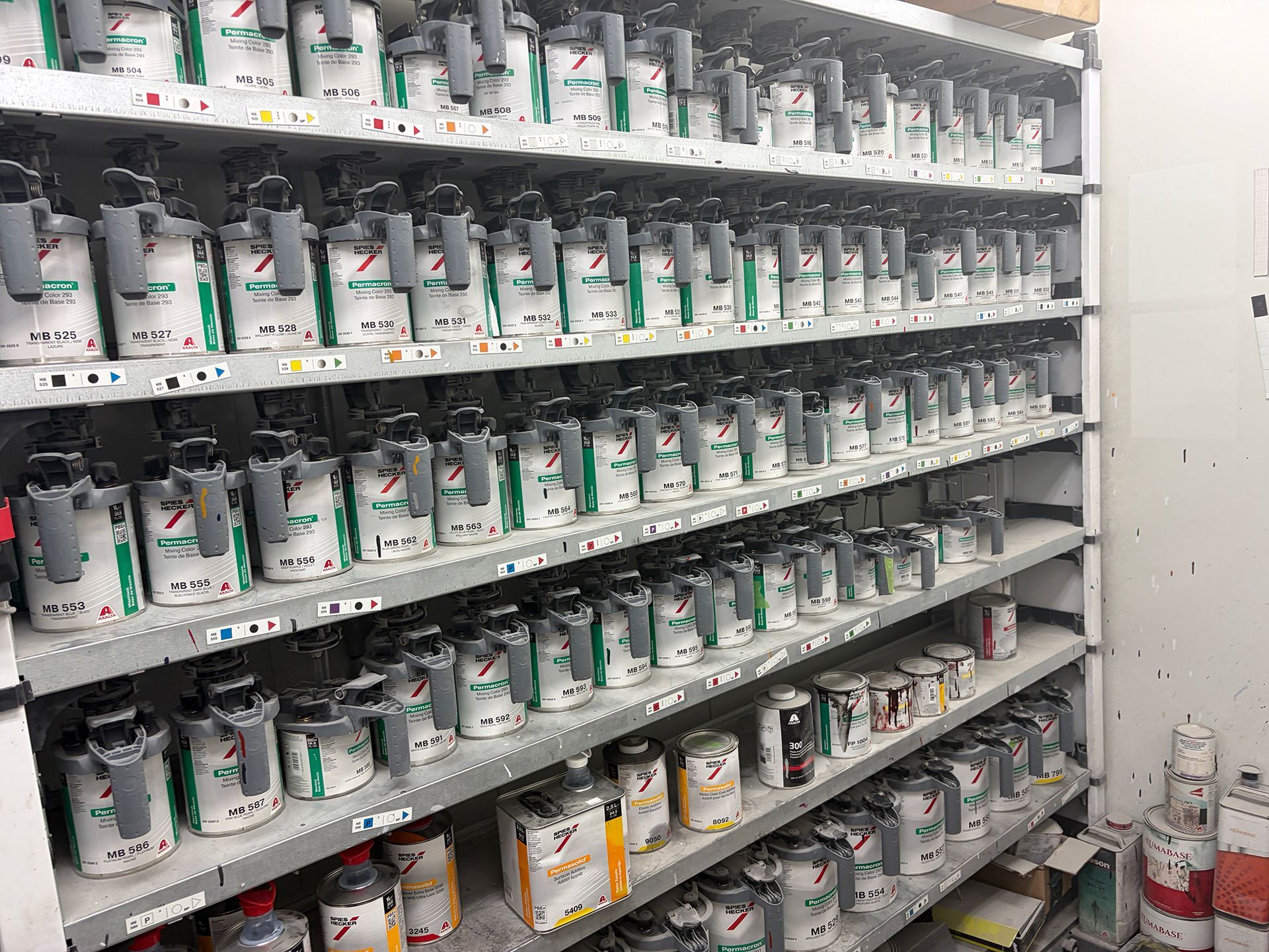 Paint cans stacked on a shelf