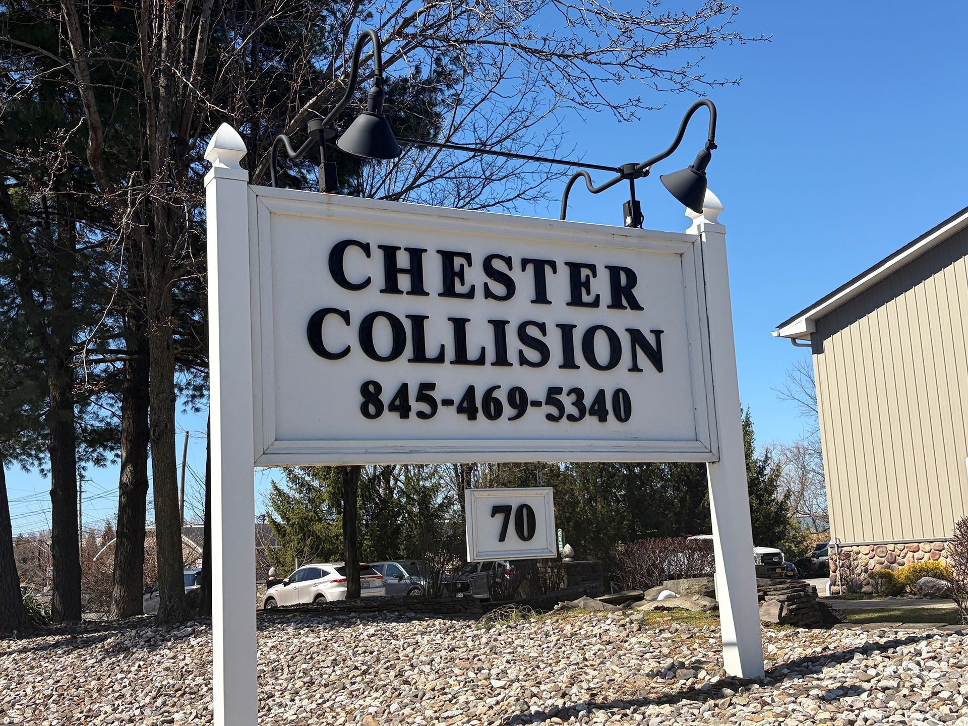 Close-up of Chester Collision Inc's road sign