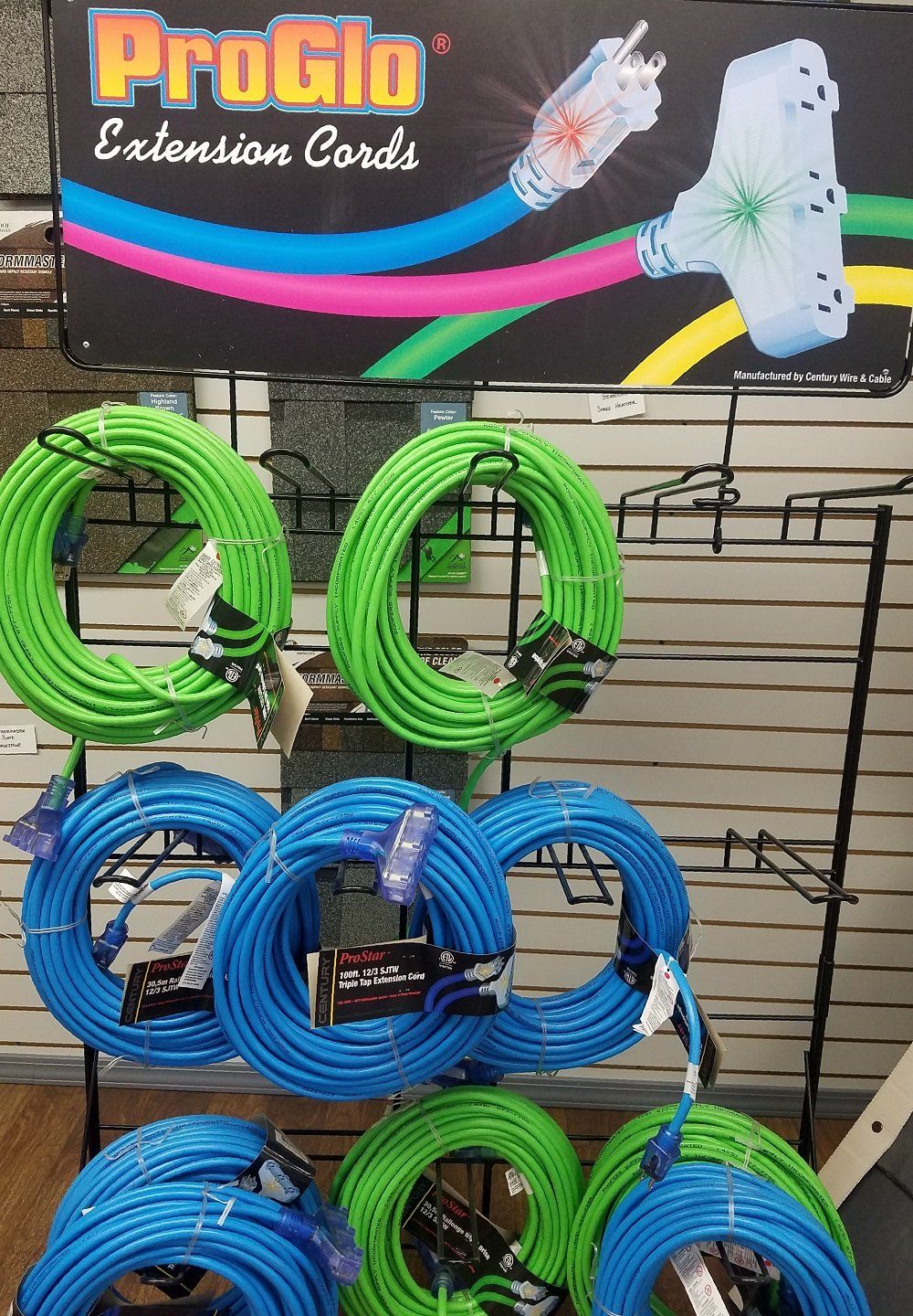 Green and blue ProGlo extension cords on display in a store.