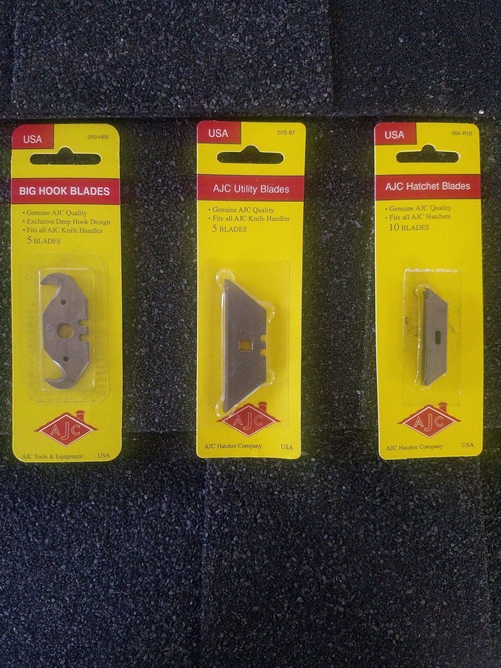 Three utility knife blades in yellow packaging.