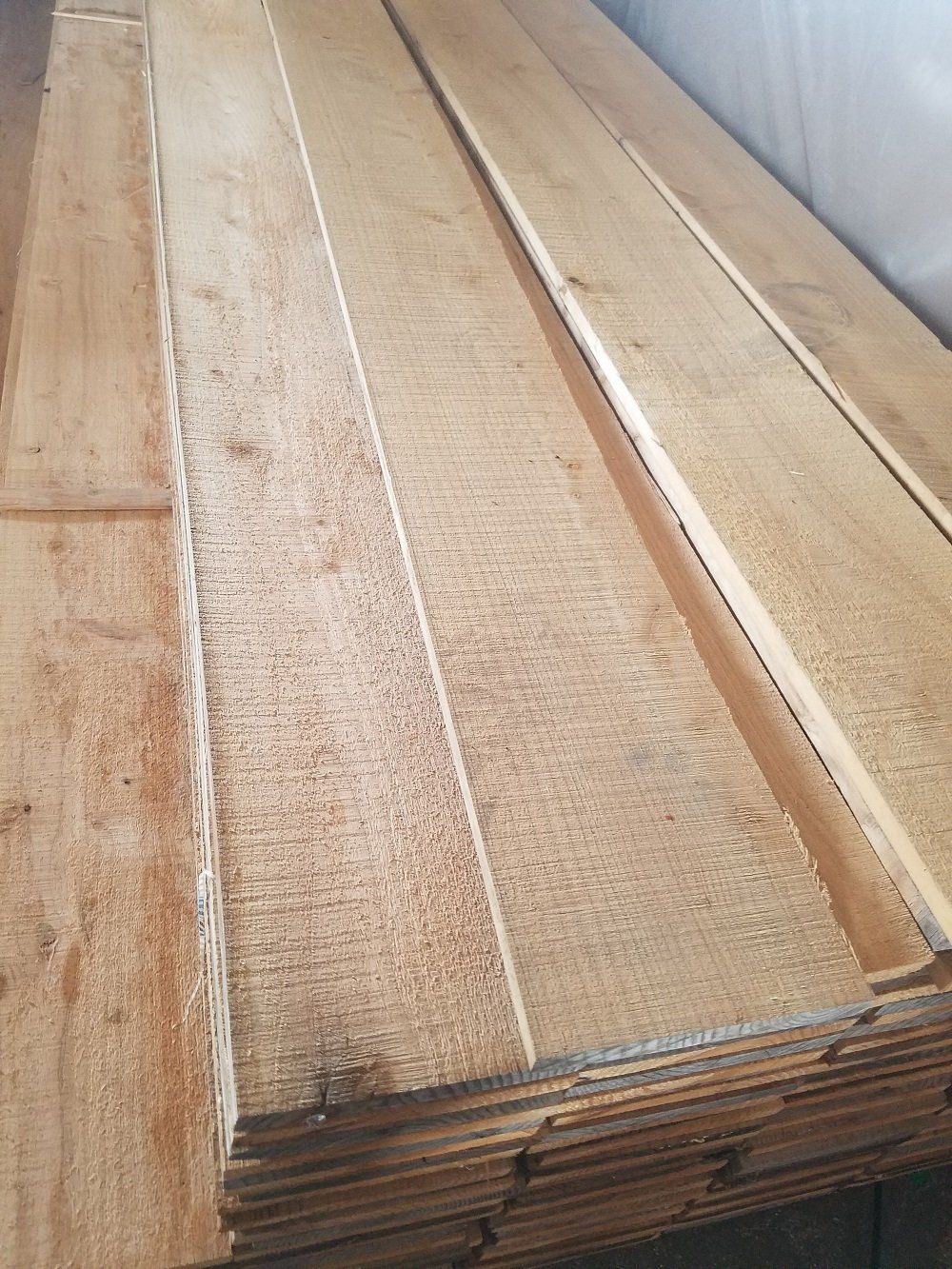 Stack of unfinished wood planks.