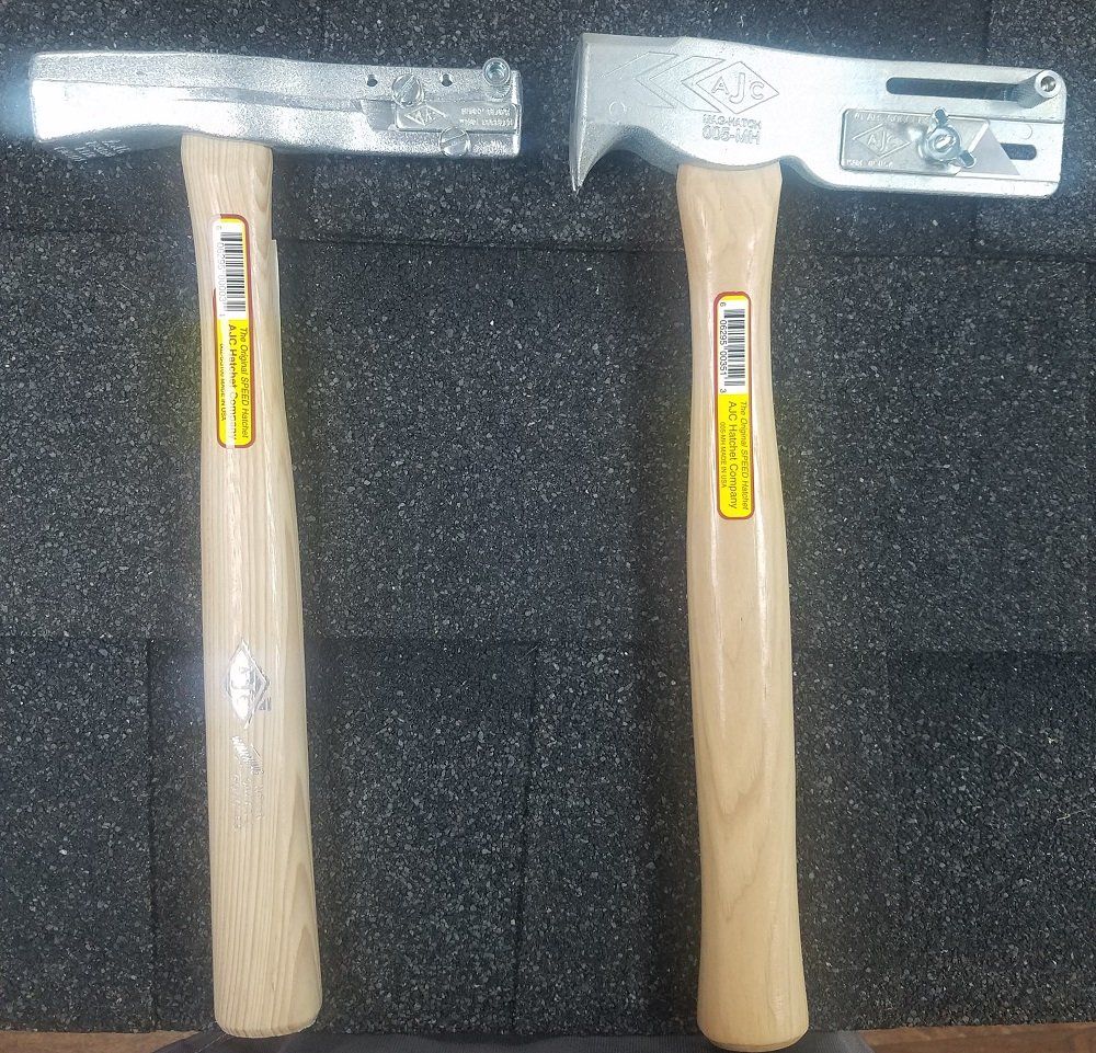 Two roofing hammers with wooden handles on a dark background.