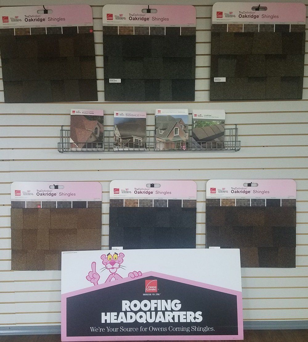 Roofing Headquarters display with shingle samples in various colors from Owens Corning.