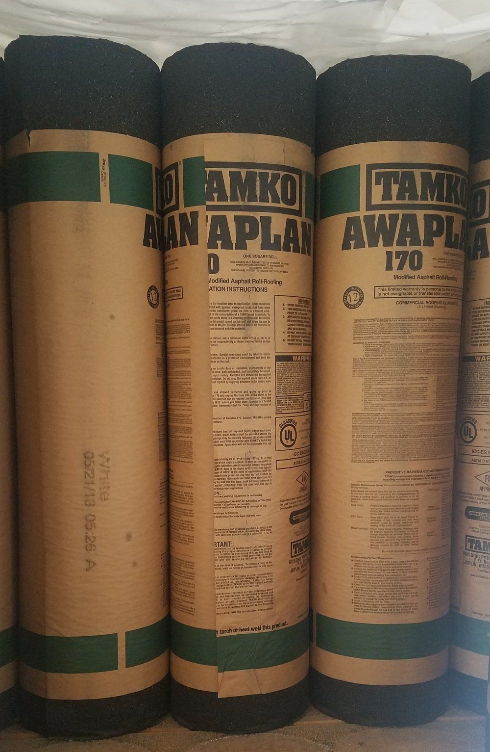 Three rolls of TAMKO roofing underlayment. Brown, black, and green labels.