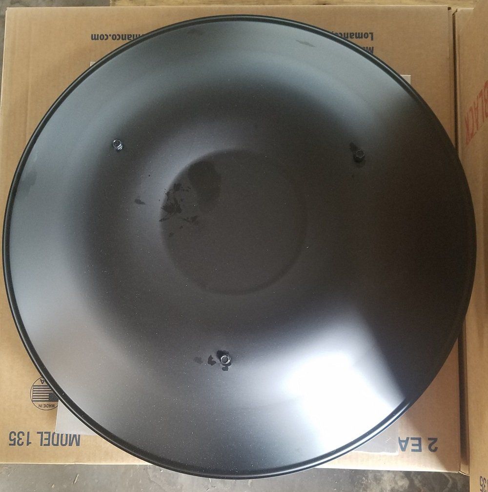 Black round metal piece, possibly a grill accessory, with three small holes.