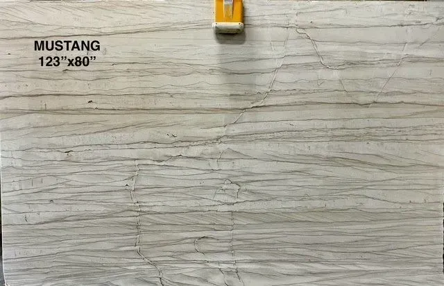 Gray marble tile sample labeled “MUSTANG 123” with a clamp at the top.