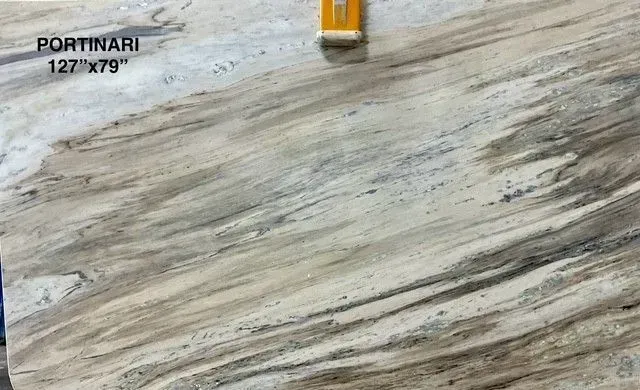 Gray-and-white marble floor tile with diagonal veining, labeled “PORTINARI 127x79” in the corner