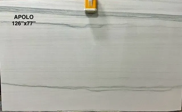 White tile sample labeled “APOLO 12x77” with a clip at the top center.