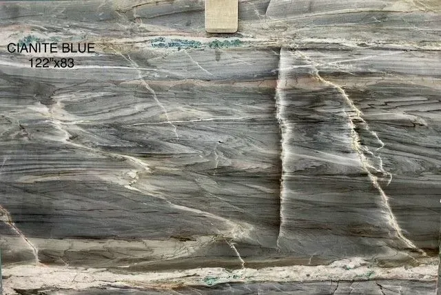 Gray-blue marble slab with white veining and a visible sample label in the top left.