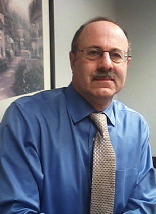 Jeff Morgenstern wearing blue long sleeves with tie