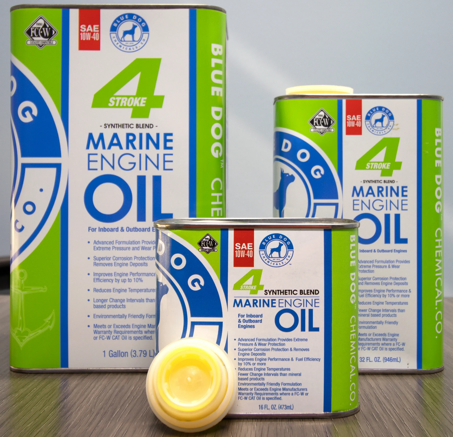 Three cans of blue dog marine engine oil on a table