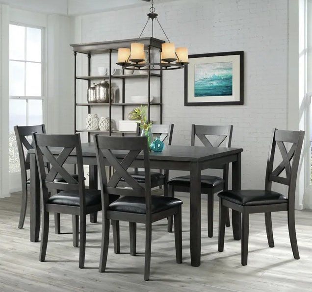A dining room with a table and chairs and a chandelier