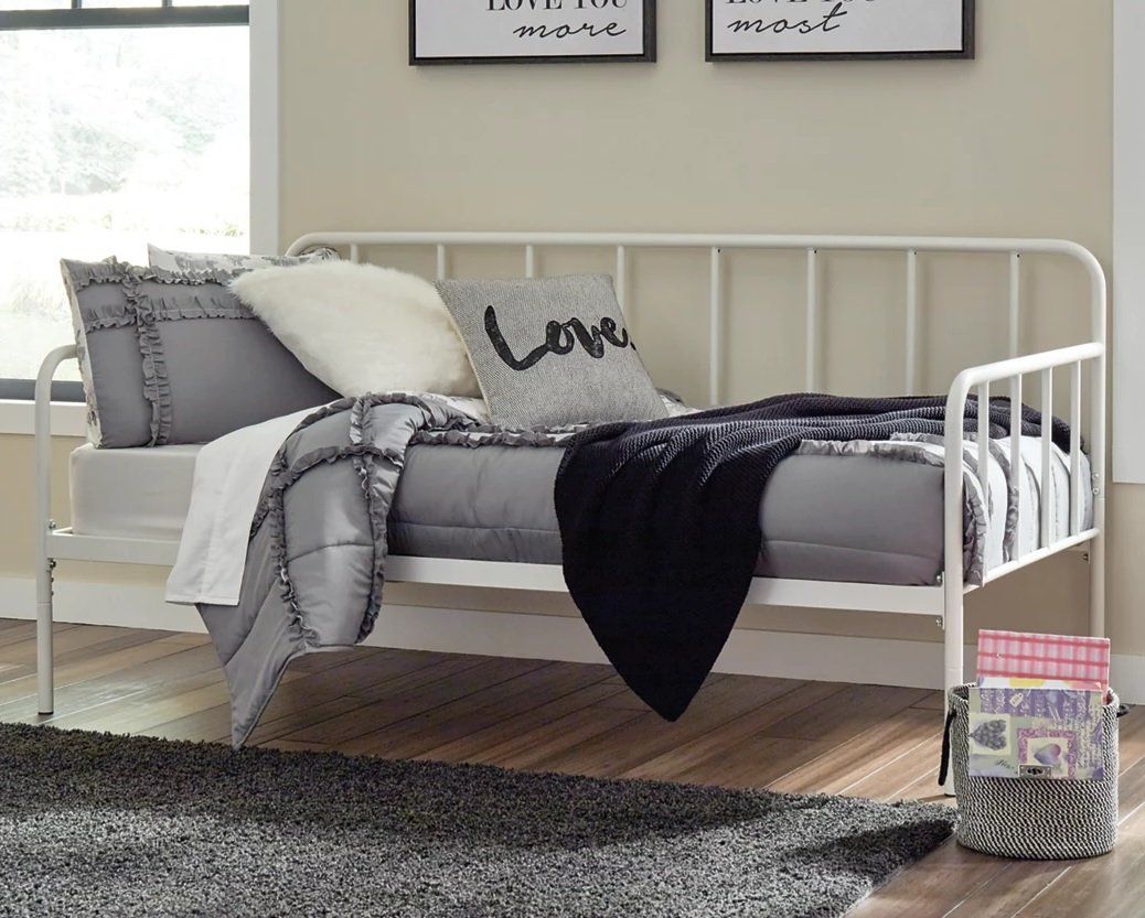 A day bed with a pillow that says love on it