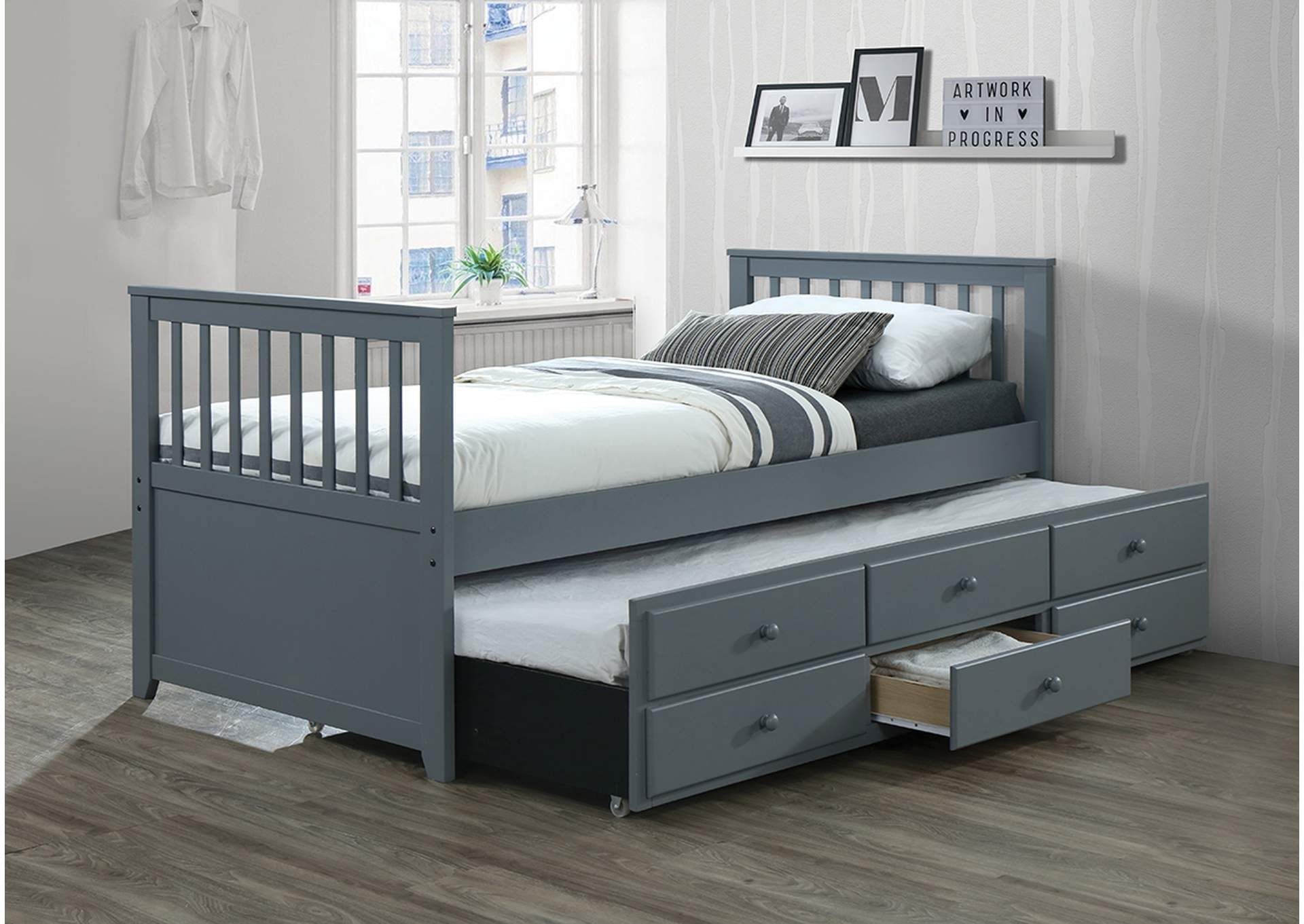 A grey day bed with drawers underneath it in a bedroom.