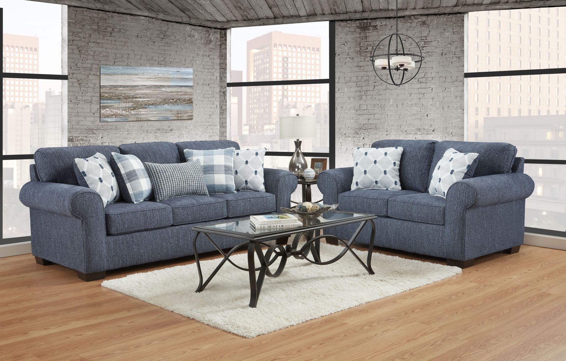 A living room with two blue couches and a coffee table.
