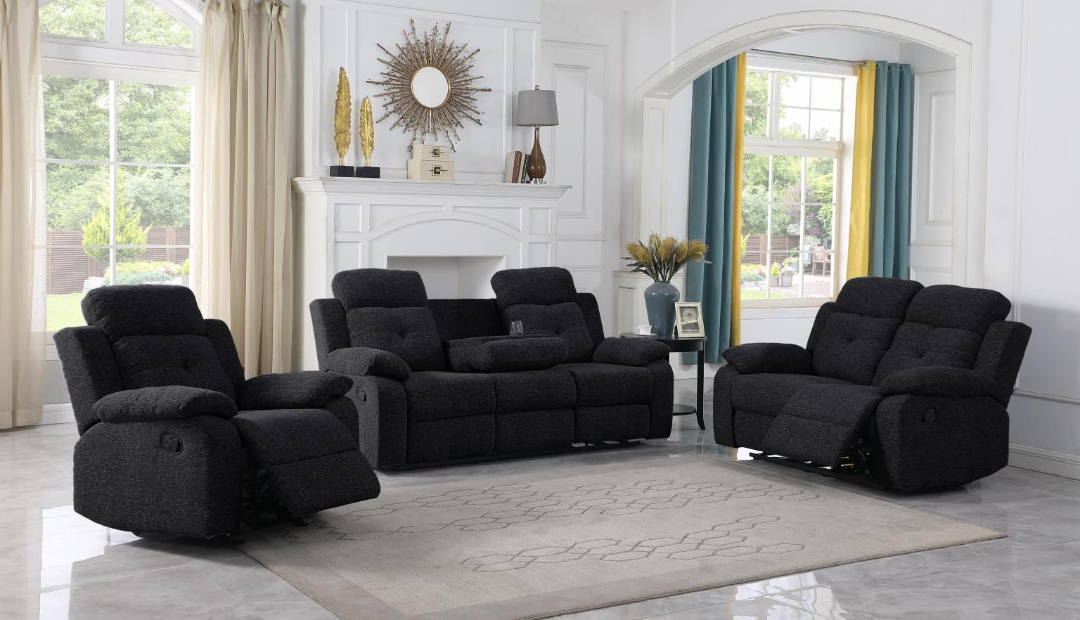 A living room with black furniture and a fireplace.