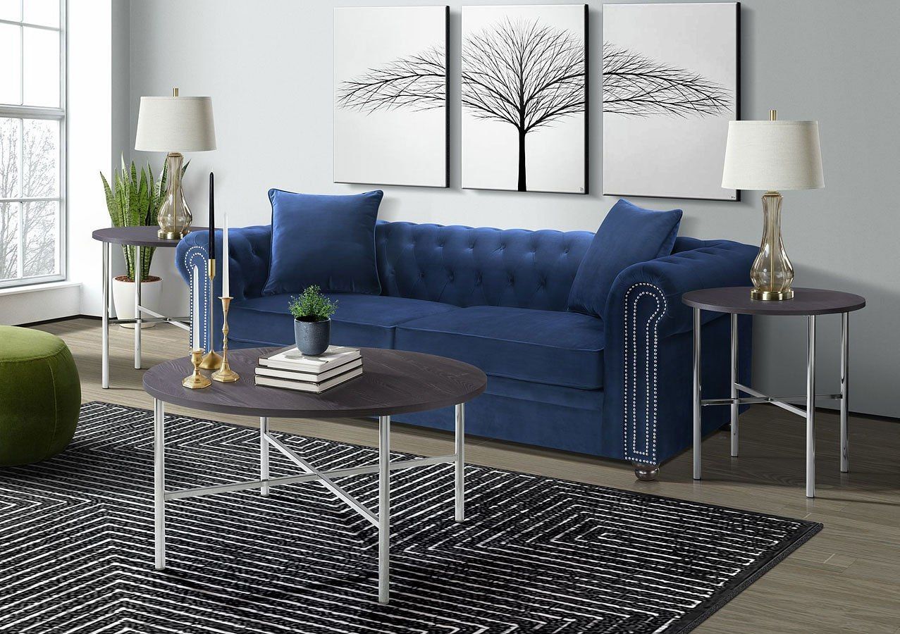A living room with a blue couch and two coffee tables