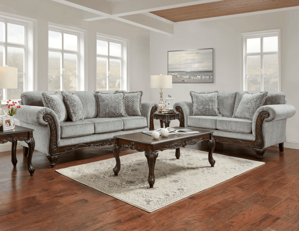 A living room with two couches , a coffee table , and a rug.