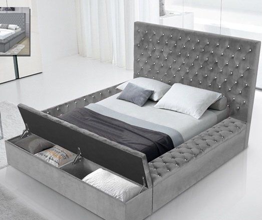 A bed with a tufted headboard and drawers underneath it in a bedroom.