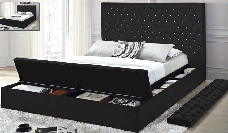 A bed with a black headboard and white sheets