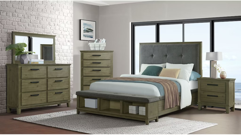 A bedroom with a bed , dresser , nightstand , mirror and rug.