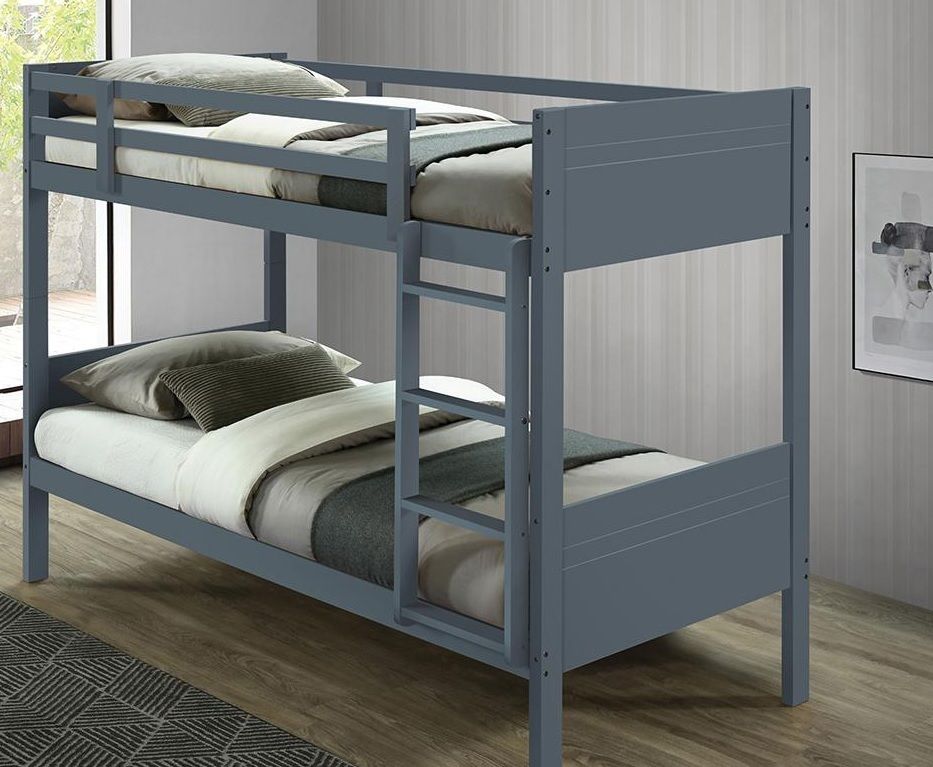 A blue bunk bed is sitting in a bedroom next to a window.