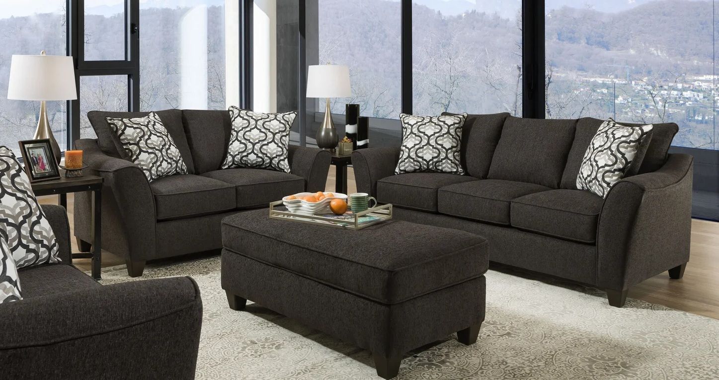 A living room filled with furniture and a large window.