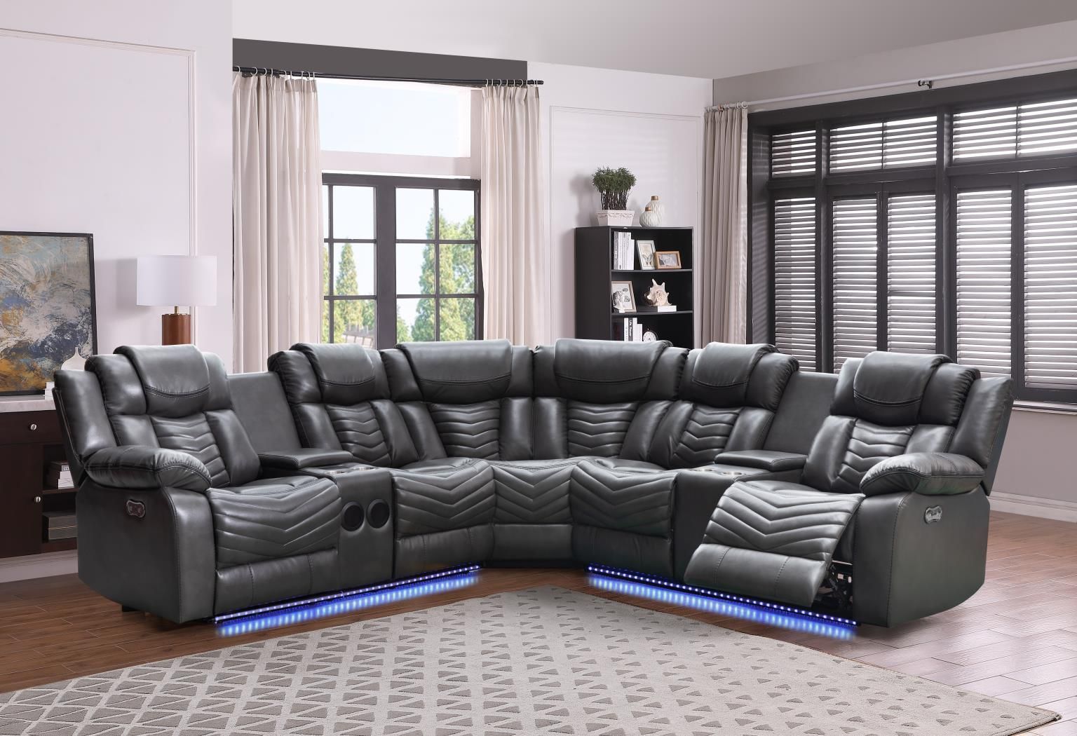 A living room with a gray sectional couch and blue lights.