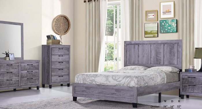 A bedroom with a bed , dresser , nightstand and mirror.