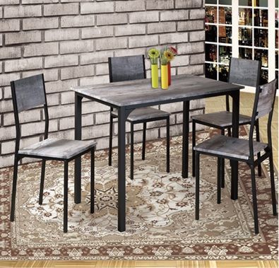 A table and chairs in a room with a brick wall