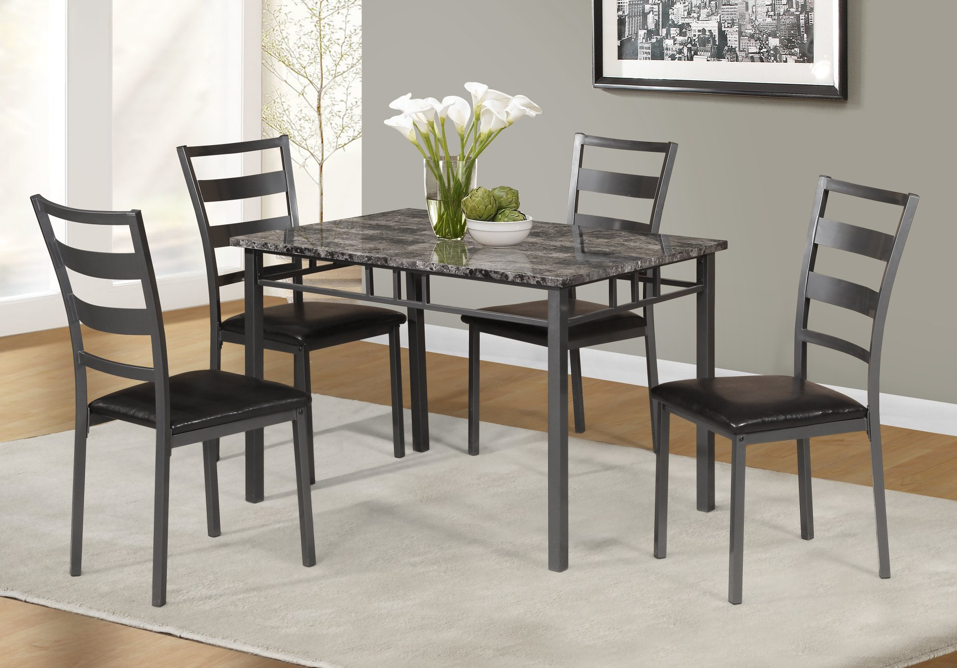 A marble dining table with black chairs in a living room