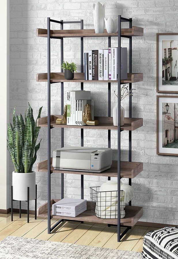 A living room with a bookshelf filled with books and a printer.