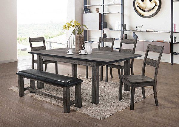 A dining room with a table and chairs and a bench.