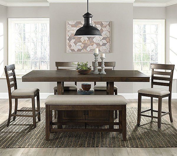 A dining room with a table , chairs , and a bench.