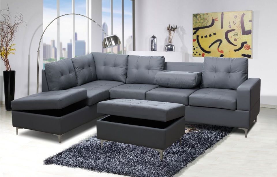 A living room with a sectional couch and ottoman