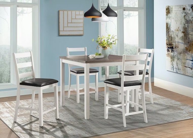 A dining room with a table and chairs and a rug.