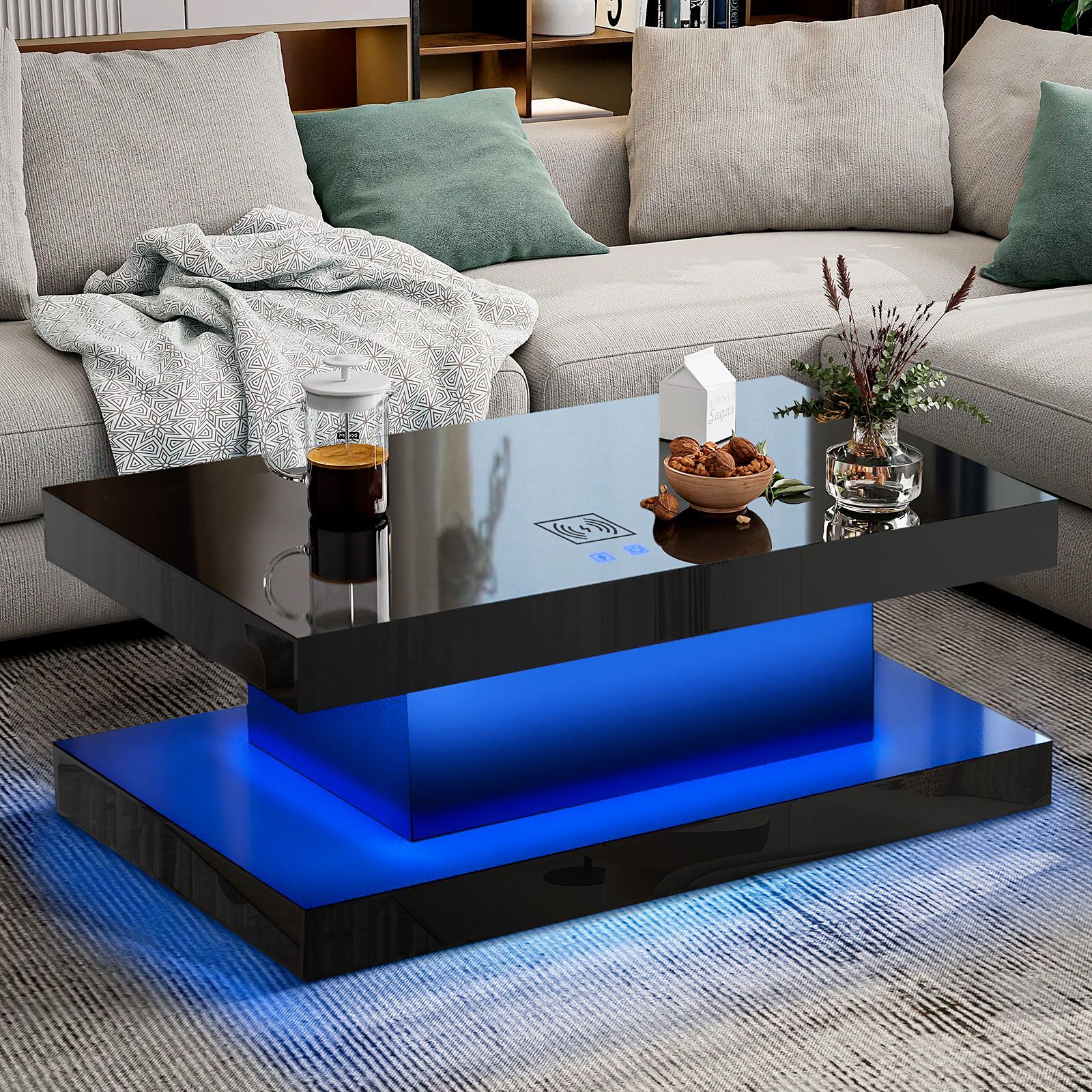 A black coffee table with blue lights is in a living room next to a couch.