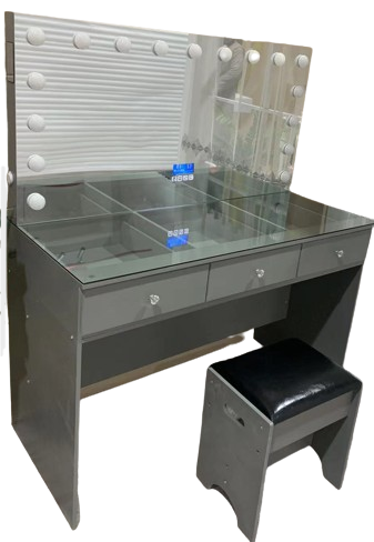 A vanity with a mirror and drawers and a stool.