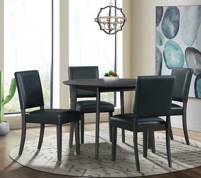 A dining room with a table and chairs and a painting on the wall