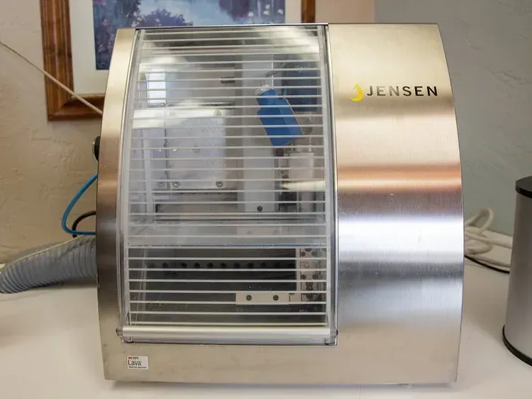 Silver Jensen countertop microwave with a windowed door on a kitchen counter