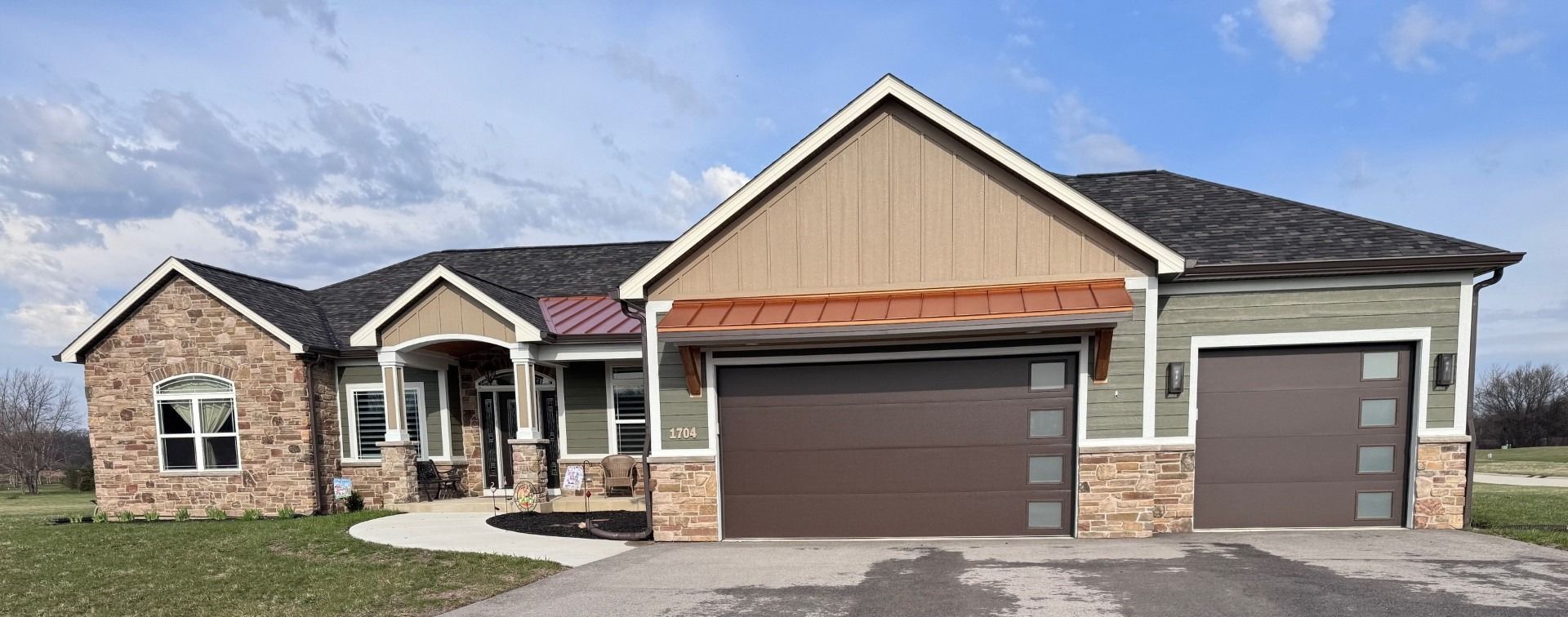 New single-story brick house with two garage doors and a covered front porch