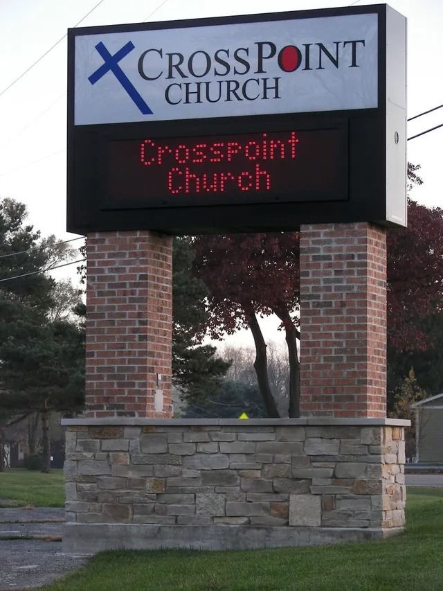 Sign for CrossPoint Church. Brick pillars support a sign displaying