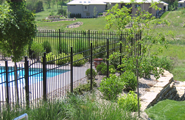 Black metal fences along the pool and garden