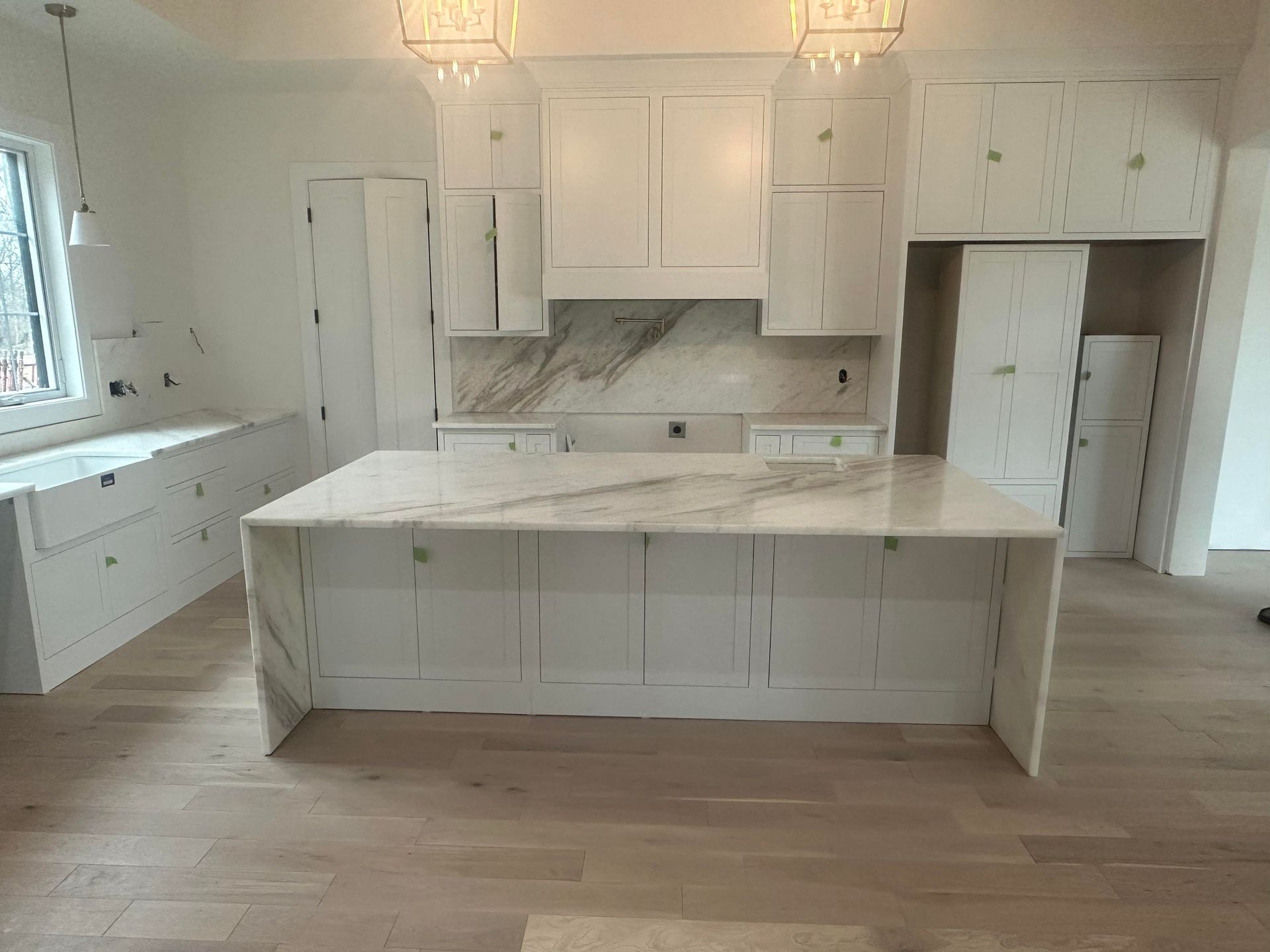 There is a large island with custom countertop in the middle of the kitchen.