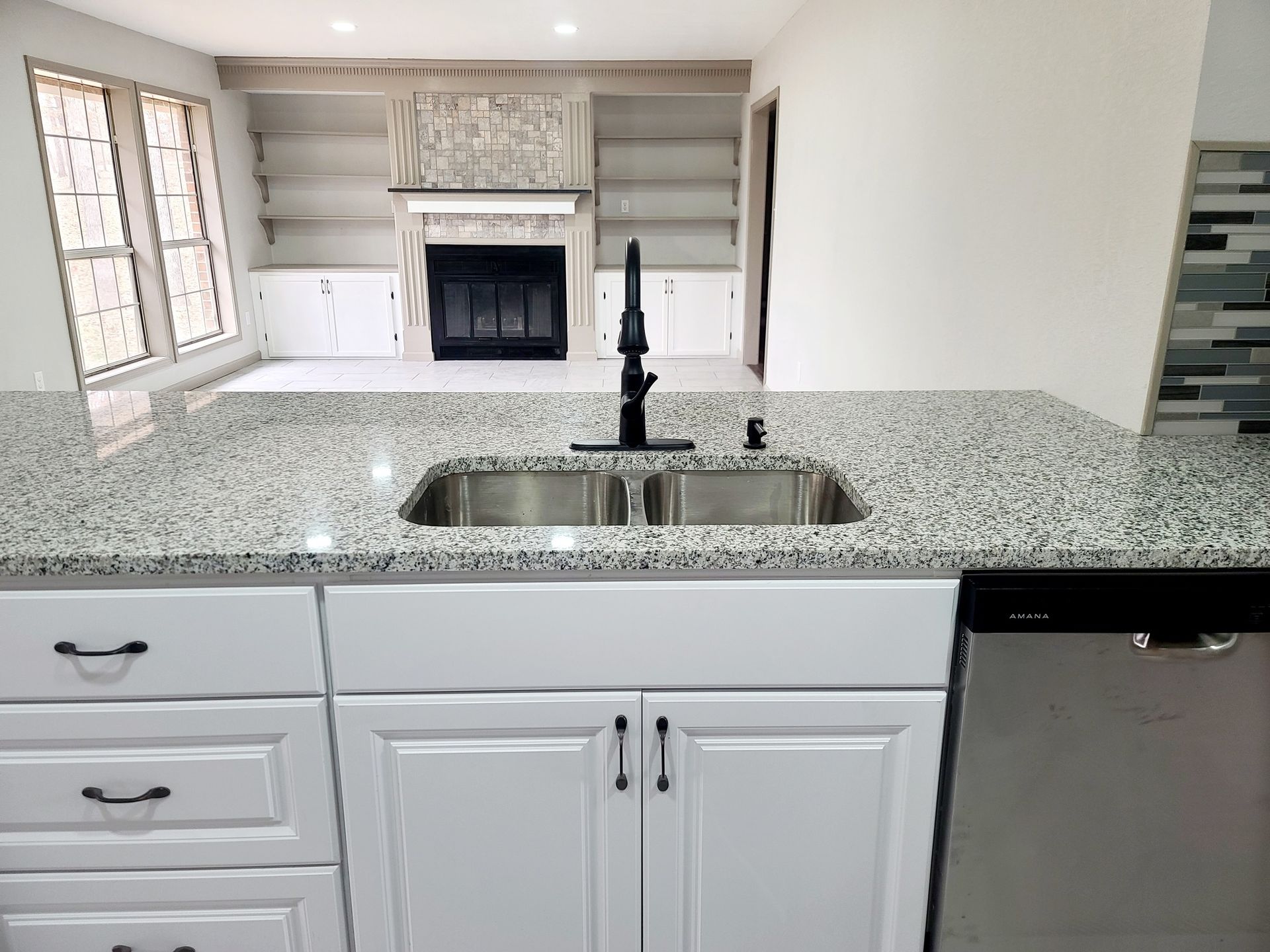 A kitchen with a sink with a countertop