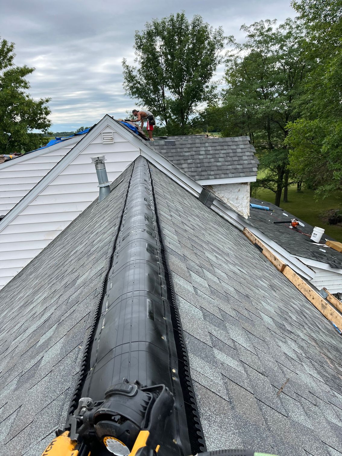 a person is working on the roof of a house